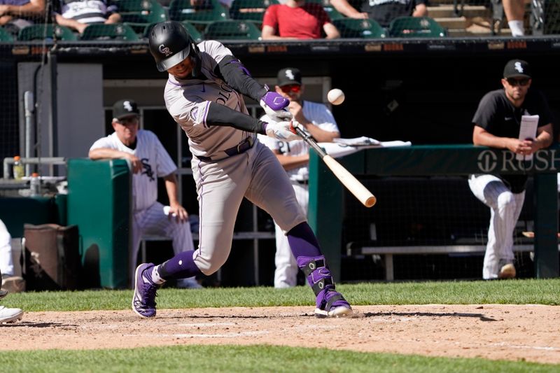 Jun 30, 2024; Chicago, Illinois, USA; Colorado Rockies shortstop Ezequiel Tovar (14) hits a one run single against the Chicago White Sox during the thirteenth inning at Guaranteed Rate Field. Mandatory Credit: David Banks-USA TODAY Sports