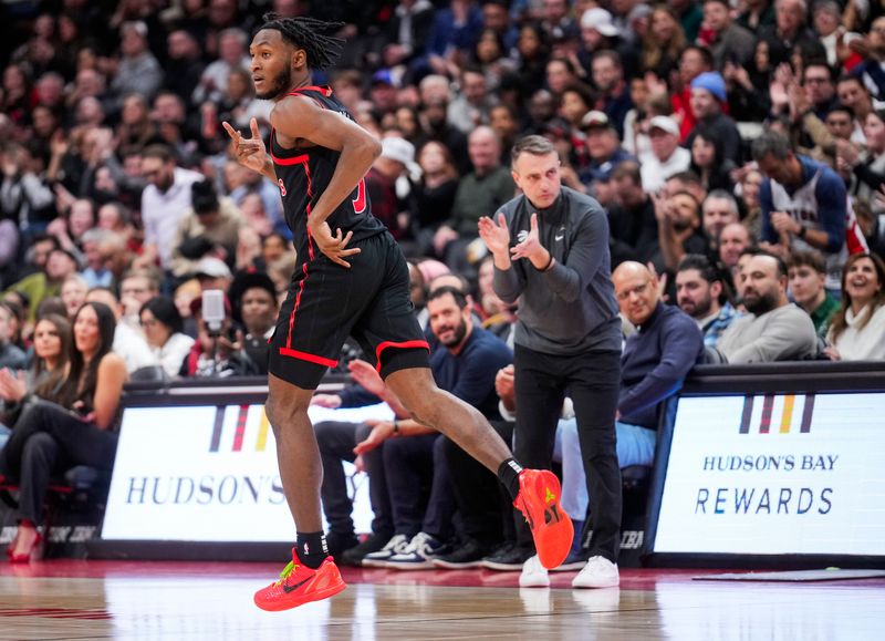 TORONTO, ON - FEBRUARY 9: Immanuel Quickley #5 of the Toronto Raptors celebrates a three point shot against the Houston Rockets during the first half of their basketball game at the Scotiabank Arena on February 9, 2024 in Toronto, Ontario, Canada. NOTE TO USER: User expressly acknowledges and agrees that, by downloading and/or using this Photograph, user is consenting to the terms and conditions of the Getty Images License Agreement. (Photo by Mark Blinch/Getty Images)