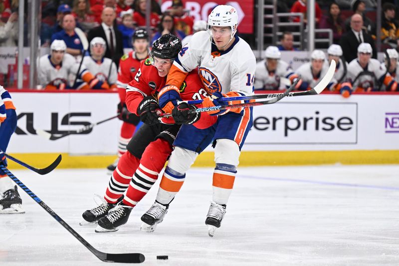 Jan 19, 2024; Chicago, Illinois, USA; Chicago Blackhawks defenseman Alex Vlasic (72) and New York Islanders forward Bo Horvat (14) battle for position while chasing after a loose puck in the third period at United Center. Mandatory Credit: Jamie Sabau-USA TODAY Sports