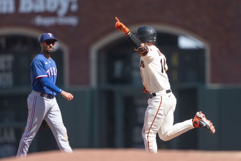 Aug 13, 2023; San Francisco, California, USA; Texas Rangers second baseman Marcus Semien (2) watches San Francisco Giants catcher Patrick Bailey (14) run the bases after hitting a two run walk off home run during the tenth inning at Oracle Park. Mandatory Credit: Stan Szeto-USA TODAY Sports