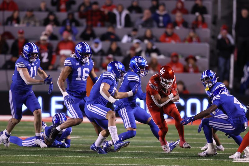 Nov 9, 2024; Salt Lake City, Utah, USA; Utah Utes running back Micah Bernard (2) is tackled by the Brigham Young Cougars defense during the fourth quarter at Rice-Eccles Stadium. Mandatory Credit: Rob Gray-Imagn Images