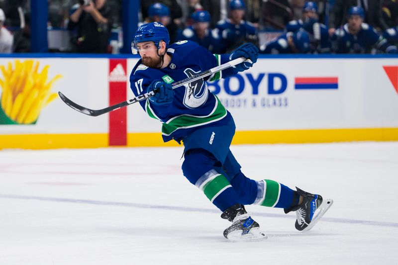 Dec 9, 2023; Vancouver, British Columbia, CAN; Vancouver Canucks defenseman Filip Hronek (17) shoots against the Carolina Hurricanes in the first period at Rogers Arena. Mandatory Credit: Bob Frid-USA TODAY Sports