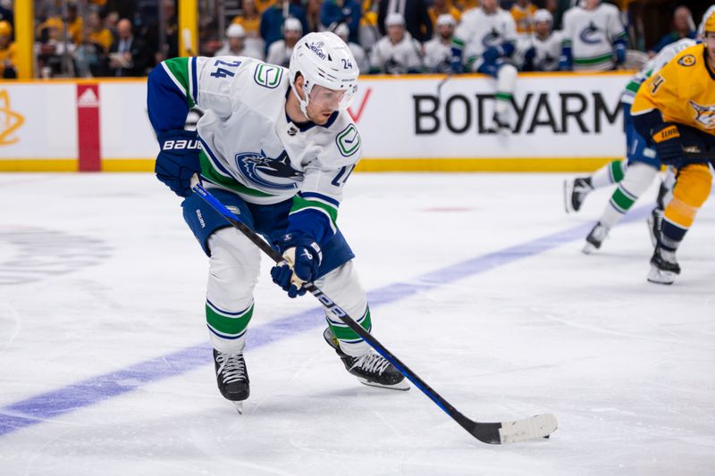 Apr 26, 2024; Nashville, Tennessee, USA; Vancouver Canucks center Pius Suter (24) skates against the Nashville Predators during the second period in game three of the first round of the 2024 Stanley Cup Playoffs at Bridgestone Arena. Mandatory Credit: Steve Roberts-USA TODAY Sports