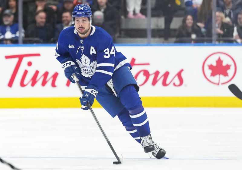 Apr 8, 2024; Toronto, Ontario, CAN; Toronto Maple Leafs center Auston Matthews (34) skates with the puck against the Pittsburgh Penguins during the third period at Scotiabank Arena. Mandatory Credit: Nick Turchiaro-USA TODAY Sports