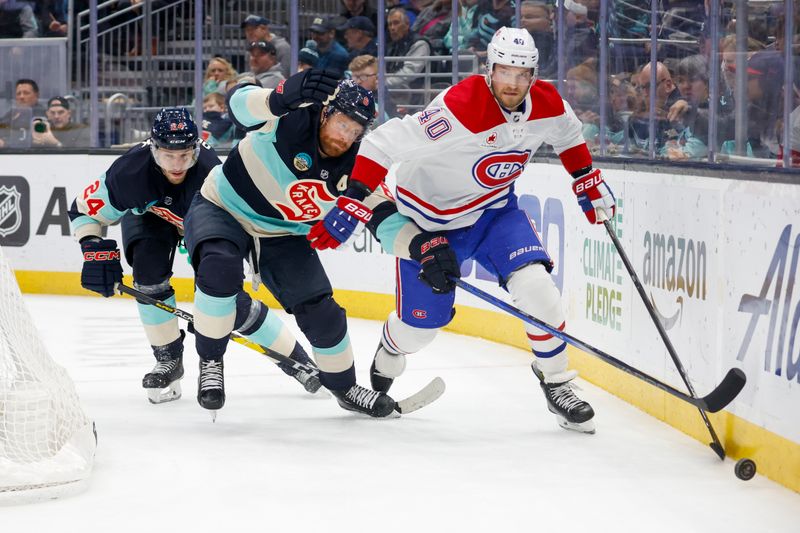 Mar 24, 2024; Seattle, Washington, USA; Montreal Canadiens right wing Joel Armia (40) pursues the puck against Seattle Kraken defenseman Adam Larsson (6) and defenseman Jamie Oleksiak (24) during the second period at Climate Pledge Arena. Mandatory Credit: Joe Nicholson-USA TODAY Sports