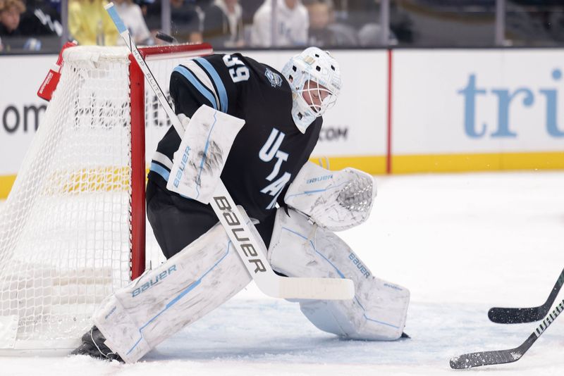 Oct 28, 2024; Salt Lake City, Utah, USA;  Utah Hockey Club goaltender Connor Ingram (39) blocks a shot during the first period against the San Jose Sharksat Delta Center. Mandatory Credit: Chris Nicoll-Imagn Images