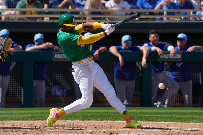 Mar 10, 2024; Mesa, Arizona, USA; Oakland Athletics center fielder Esteury Ruiz (1) hits an RBI ground out against the Kansas City Royals in the second inning at Hohokam Stadium. Mandatory Credit: Rick Scuteri-USA TODAY Sports