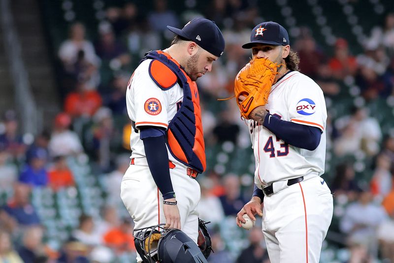 May 28, 2025; Houston, Texas, USA; Houston Astros catcher Victor Caratini (17) talks with Houston Astros starting pitcher Lance McCullers Jr. (43) during a visit to the mound against the Athletics during the fourth inning at Daikin Park. Mandatory Credit: Erik Williams-Imagn Images