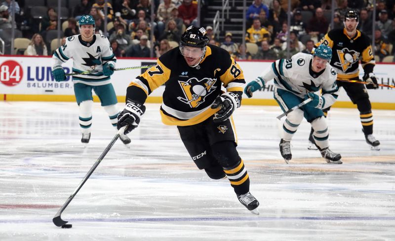 Nov 16, 2024; Pittsburgh, Pennsylvania, USA; Pittsburgh Penguins center Sidney Crosby (87) carries the puck into the offensive zone against the San Jose Sharks during the third period at PPG Paints Arena. Mandatory Credit: Charles LeClaire-Imagn Images