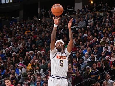 DENVER, CO - DECEMBER 25: Kentavious Caldwell-Pope #5 of the Denver Nuggets three point basket during the game against the Golden State Warriors  on December 25, 2023 at the Ball Arena in Denver, Colorado. NOTE TO USER: User expressly acknowledges and agrees that, by downloading and/or using this Photograph, user is consenting to the terms and conditions of the Getty Images License Agreement. Mandatory Copyright Notice: Copyright 2023 NBAE (Photo by Bart Young/NBAE via Getty Images)