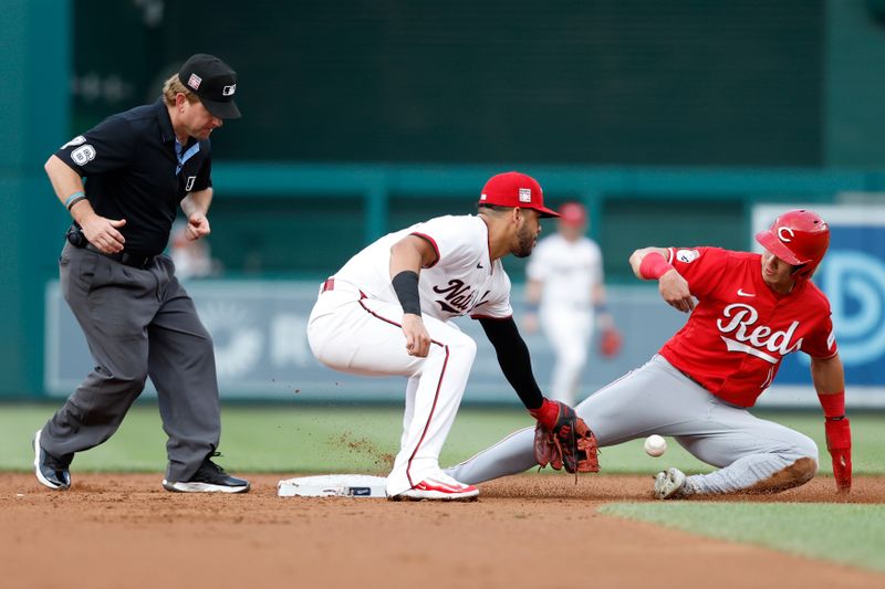 Jul 19, 2024; Washington, District of Columbia, USA; Cincinnati Reds outfielder Stuart Fairchild (17) steals second base as Washington Nationals second base Luis García Jr. (2) loses the ball on the attempted tag during the third inning at Nationals Park. Mandatory Credit: Geoff Burke-USA TODAY Sports