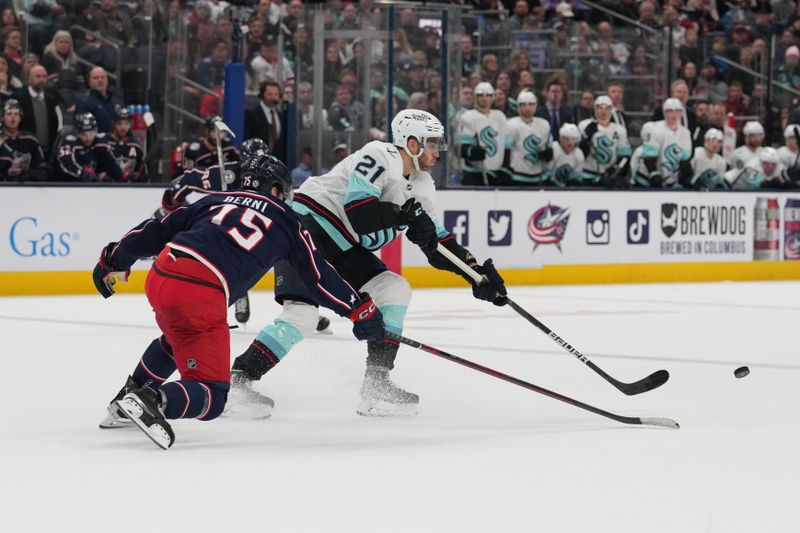 Mar 3, 2023; Columbus, Ohio, USA;  Seattle Kraken center Alex Wennberg (21) passes the puck against Columbus Blue Jackets defenseman Tim Berni (75) during the third period at Nationwide Arena. Mandatory Credit: Jason Mowry-USA TODAY Sports