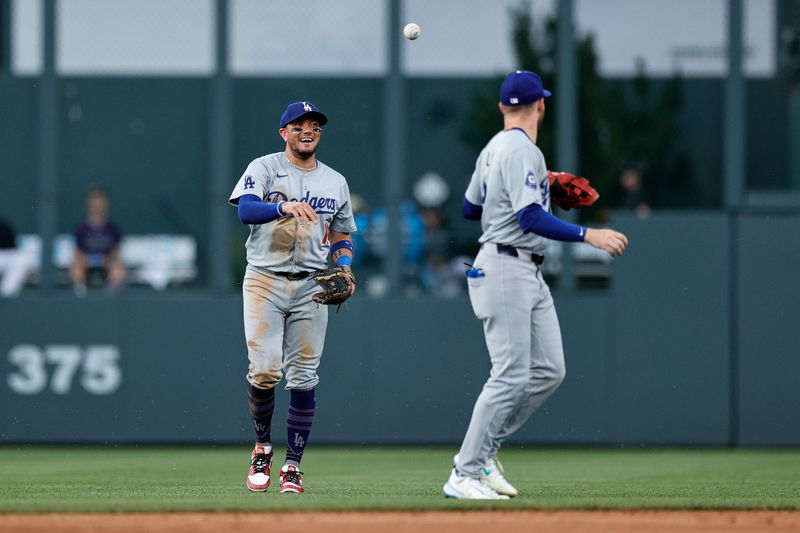 Jun 17, 2024; Denver, Colorado, USA; Los Angeles Dodgers shortstop Miguel Rojas (11) reacts with second baseman Gavin Lux (9) in the fifth inning against the Colorado Rockies at Coors Field. Mandatory Credit: Isaiah J. Downing-USA TODAY Sports