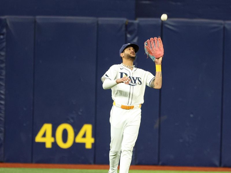 Sep 3, 2024; St. Petersburg, Florida, USA; Tampa Bay Rays outfielder Jose Siri (22) catches a fly ball against the Minnesota Twins during the third inning at Tropicana Field. Mandatory Credit: Kim Klement Neitzel-Imagn Images