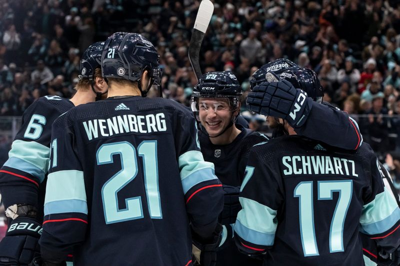 Jan 24, 2024; Seattle, Washington, USA; Seattle Kraken defenseman Vince Dunn (29), center, defenseman Adam Larsson (6), forward Alex Wennberg and forward Jaden Schwartz (17) celebrate a goal against the Chicago Blackhawks during the first period at Climate Pledge Arena. Mandatory Credit: Stephen Brashear-USA TODAY Sports