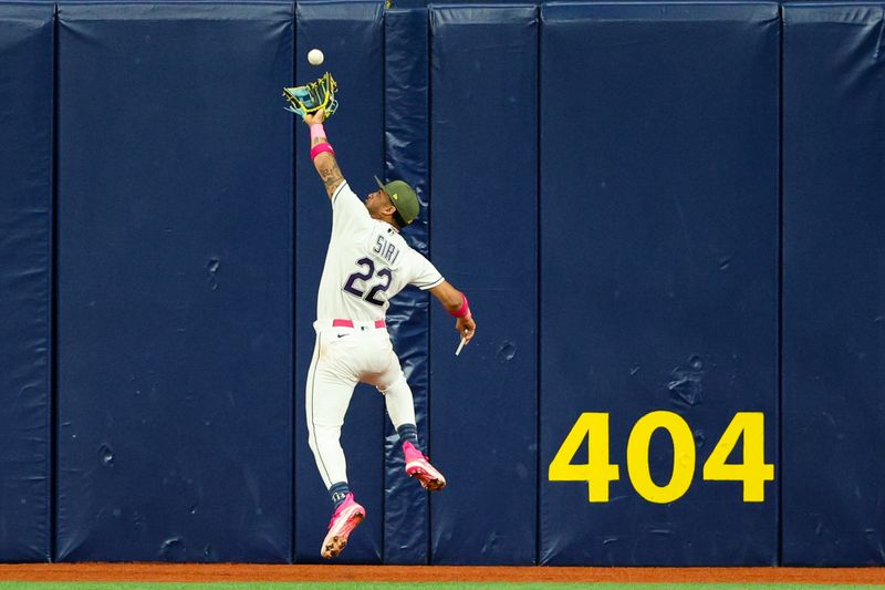 May 19, 2023; St. Petersburg, Florida, USA;  Tampa Bay Rays center fielder Jose Siri (22) leaps for a fly ball against the Milwaukee Brewers in the fifth inning at Tropicana Field. Mandatory Credit: Nathan Ray Seebeck-USA TODAY Sports