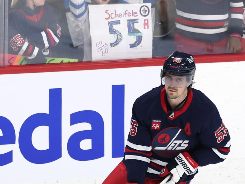 Jan 18, 2025; Winnipeg, Manitoba, CAN; Winnipeg Jets center Mark Scheifele (55) skates past fans before a game against the Calgary Flames at Canada Life Centre. Mandatory Credit: James Carey Lauder-Imagn Images