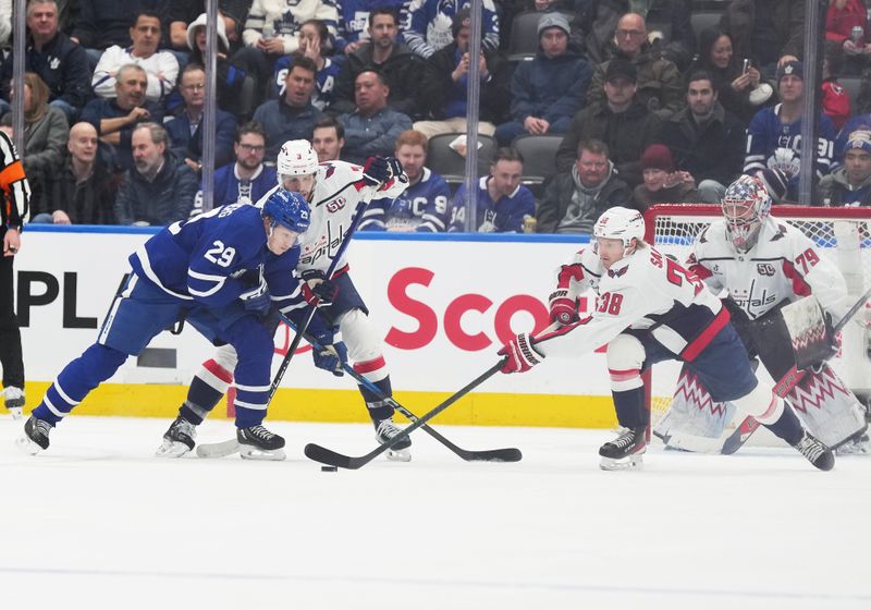 Dec 6, 2024; Toronto, Ontario, CAN; Toronto Maple Leafs right wing Pontus Holmberg (29) battles for the puck with Washington Capitals defenseman Matt Roy (3) during the second period at Scotiabank Arena. Mandatory Credit: Nick Turchiaro-Imagn Images