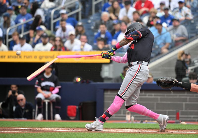 May 12, 2024; Toronto, Ontario, CAN;  Minnesota Twins shortstop Carlos Correa (4) breaks his bat as he he hits an infield fly out against the Toronto Blue Jays in the first inning at Rogers Centre. Mandatory Credit: Dan Hamilton-USA TODAY Sports