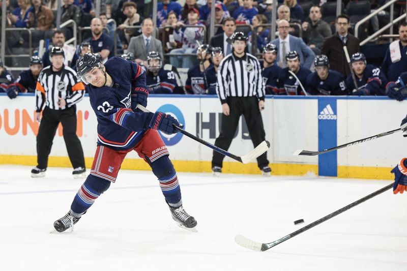  Mar 17, 2024; New York, New York, USA; New York Rangers defenseman Adam Fox (23) shoots the puck during the second period against the New York Islanders at Madison Square Garden. Mandatory Credit: Vincent Carchietta-USA TODAY Sports