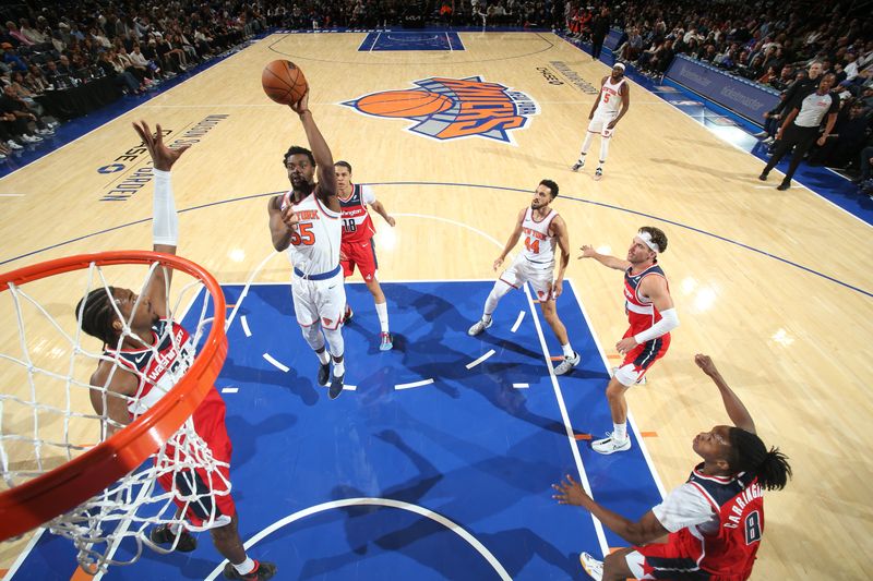 NEW YORK, NY - OCTOBER 9: Ariel Hukporti #55 of the New York Knicks drives to the basket during the game against the Washington Wizards during the 2024 NBA Preseason on October 9, 2024 at Madison Square Garden in New York City, New York.  NOTE TO USER: User expressly acknowledges and agrees that, by downloading and or using this photograph, User is consenting to the terms and conditions of the Getty Images License Agreement. Mandatory Copyright Notice: Copyright 2024 NBAE  (Photo by Nathaniel S. Butler/NBAE via Getty Images)