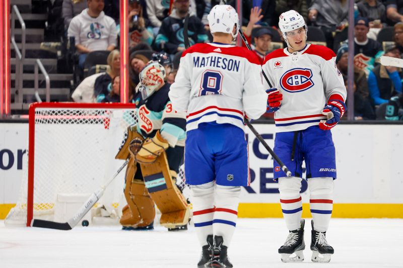 Mar 24, 2024; Seattle, Washington, USA; Montreal Canadiens left wing Juraj Slafkovsky (20) celebrates with teammates after scoring a goal against the Seattle Kraken during the first period at Climate Pledge Arena. Mandatory Credit: Joe Nicholson-USA TODAY Sports