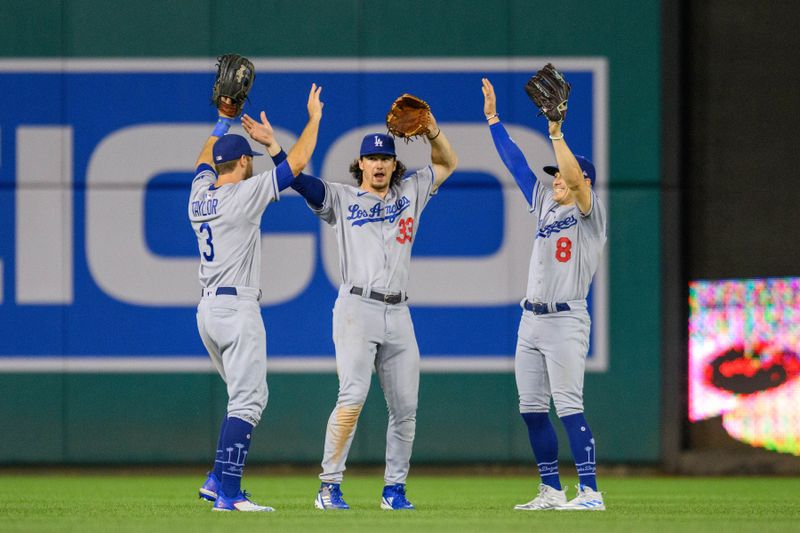 Sep 8, 2023; Washington, District of Columbia, USA; Los Angeles Dodgers shortstop Chris Taylor (3), center fielder James Outman (33), and shortstop Enrique Hernandez (8) celebrate after winning the game against the Washington Nationals at Nationals Park. Mandatory Credit: Reggie Hildred-USA TODAY Sports