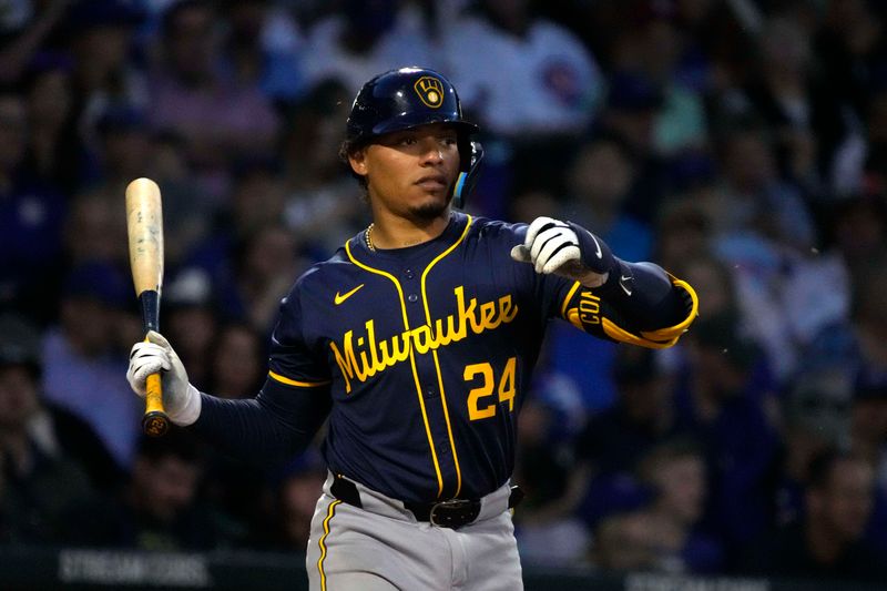 Mar 12, 2024; Mesa, Arizona, USA; Milwaukee Brewers catcher William Contreras (24) swats at bugs against the Chicago Cubs in the third inning at Sloan Park. Mandatory Credit: Rick Scuteri-USA TODAY Sports