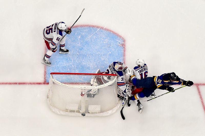 Jan 11, 2024; St. Louis, Missouri, USA;  St. Louis Blues center Jordan Kyrou (25) trips over New York Rangers goaltender Igor Shesterkin (31) and center Vincent Trocheck (16) during the third period at Enterprise Center. Mandatory Credit: Jeff Curry-USA TODAY Sports