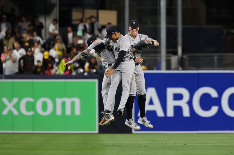 May 25, 2024; San Diego, California, USA; New York Yankees outfielders Alex Verdugo (24), Juan Soto (22) and Aaron Judge (99) celebrate after defeating the San Diego Padres at Petco Park. Mandatory Credit: Chadd Cady-USA TODAY Sports