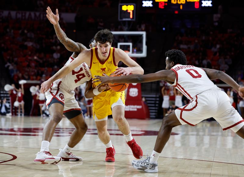 Jan 6, 2024; Norman, Oklahoma, USA; Iowa State Cyclones forward Milan Momcilovic (22) drives between Oklahoma Sooners forward Jalon Moore (14) and guard Le'Tre Darthard (0) during the first half at Lloyd Noble Center. Mandatory Credit: Alonzo Adams-USA TODAY Sports