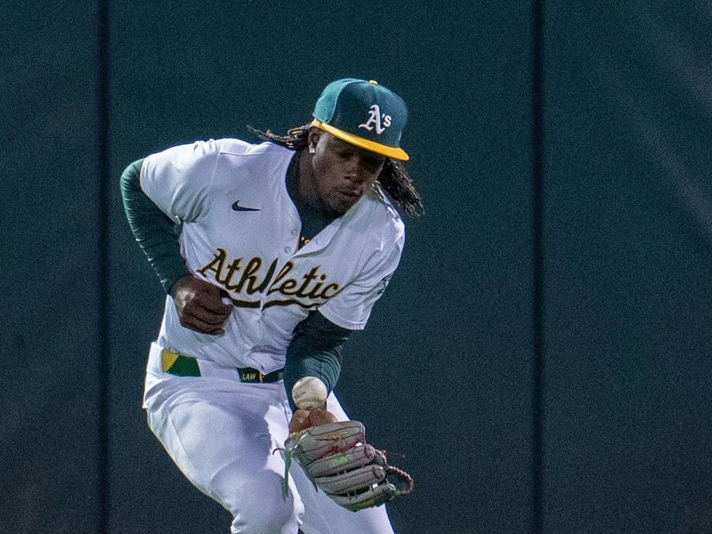 May 6, 2024; Oakland, California, USA; Oakland Athletics outfielder Tyler Nevin (26) fields a ball during the ninth inning against the Texas Rangers at Oakland-Alameda County Coliseum. Mandatory Credit: Neville E. Guard-USA TODAY Sports