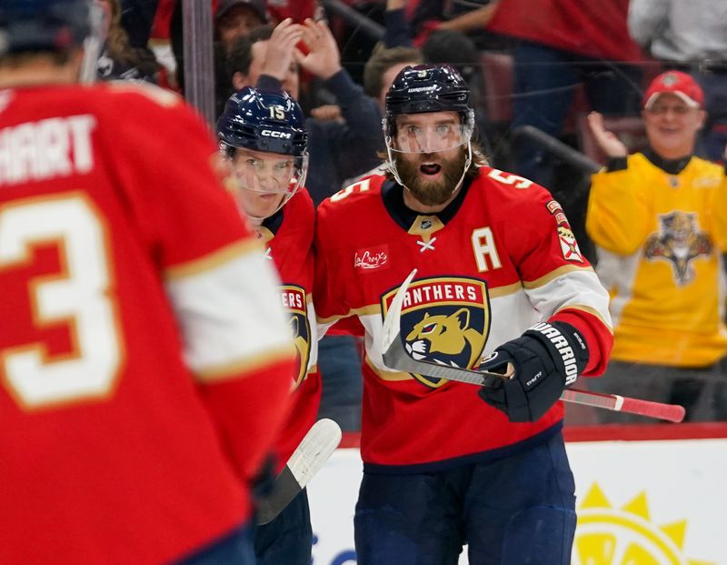 Dec 29, 2025; Sunrise, Florida, USA; Florida Panthers defenseman Aaron Ekblad (5) and center Anton Lundell (15) celebrate his goal against the Washington Capitals during the third period at Amerant Bank Arena. Mandatory Credit: Jeff Romance-Imagn Images