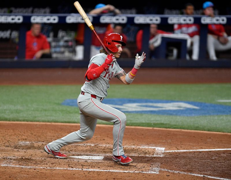 May 11, 2024; Miami, Florida, USA;  Philadelphia Phillies second baseman Bryson Stott (5) hits a triple during the sixth inning against the Miami Marlins at loanDepot Park. Mandatory Credit: Michael Laughlin-USA TODAY Sports