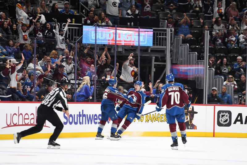 Sep 29, 2024; Denver, Colorado, USA; Colorado Avalanche center Calum Ritchie (71) celebrates with defenseman Erik Brannstrom (26) after a goal during the third period against the Utah Hockey Club at Ball Arena. Mandatory Credit: Christopher Hanewinckel-Imagn Images