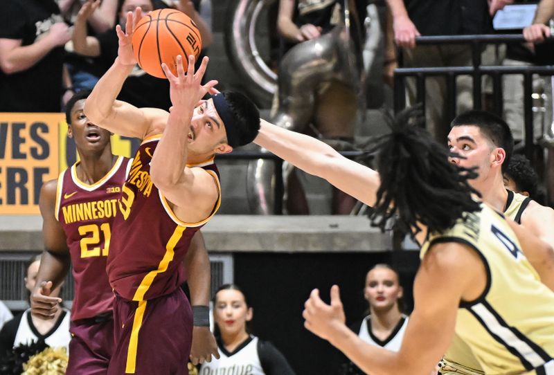 Feb 15, 2024; West Lafayette, Indiana, USA; Minnesota Golden Gophers forward Dawson Garcia (3) looks to corral a loose ball in front of Purdue Boilermakers center Zach Edey (15) during the first half at Mackey Arena. Mandatory Credit: Robert Goddin-USA TODAY Sports