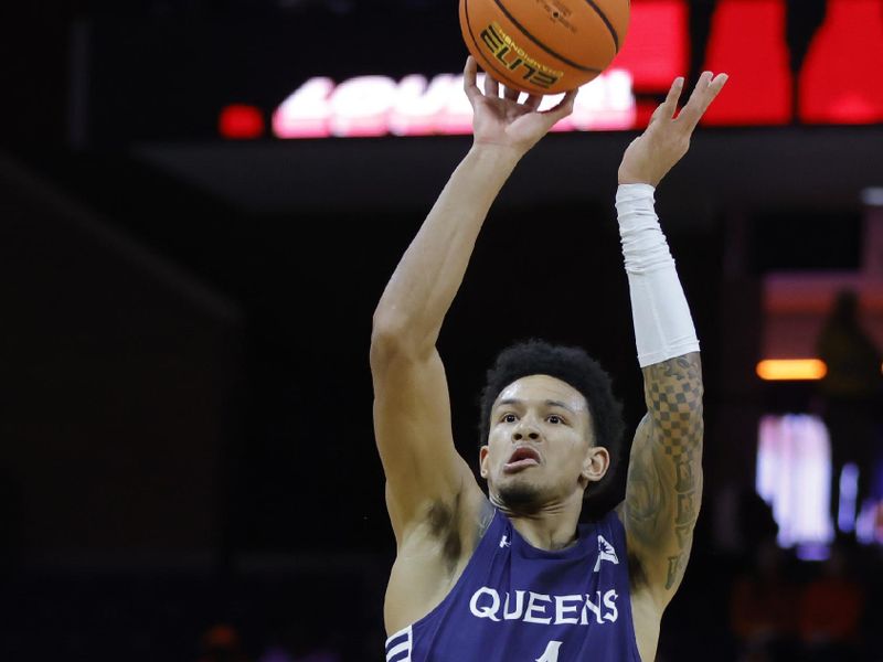Nov 28, 2025; Charlottesville, Virginia, USA; Queens University of Charlotte Royals guard Nasir Mann (1) shoots the ball over Virginia Cavaliers guard Jacari White (6) during the first half at John Paul Jones Arena. Mandatory Credit: Amber Searls-Imagn Images