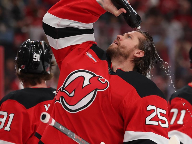 Nov 6, 2025; Newark, New Jersey, USA; New Jersey Devils goaltender Jacob Markstrom (25) sprays water on his head during the first period of their game against the Montréal Canadiens at Prudential Center. Mandatory Credit: Ed Mulholland-Imagn Images