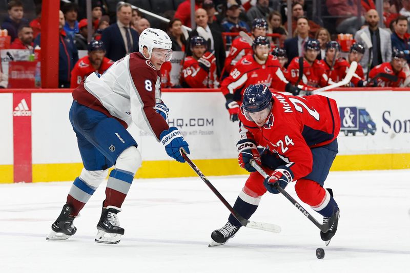 Feb 13, 2024; Washington, District of Columbia, USA; Washington Capitals center Connor McMichael (24) skates with the puck as Colorado Avalanche defenseman Cale Makar (8) defends in the third period at Capital One Arena. Mandatory Credit: Geoff Burke-USA TODAY Sports