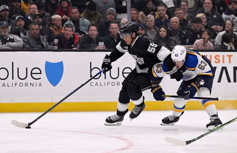 Mar 5, 2025; Los Angeles, California, USA;  Los Angeles Kings right wing Quinton Byfield (55) controls the puck with pressure from St. Louis Blues left wing Jake Neighbours (63) during the second period at Crypto.com Arena. Mandatory Credit: Alex Gallardo-Imagn Images