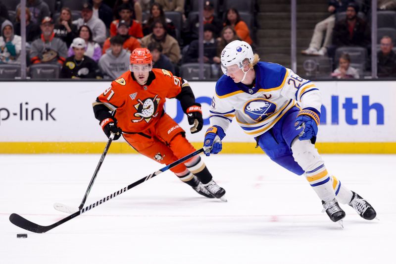 Nov 22, 2024; Anaheim, California, USA; Buffalo Sabres defenseman Rasmus Dahlin (26) moves the puck ahead of Anaheim Ducks center Leo Carlsson (91) during overtime at Honda Center. Mandatory Credit: Ryan Sun-Imagn Images