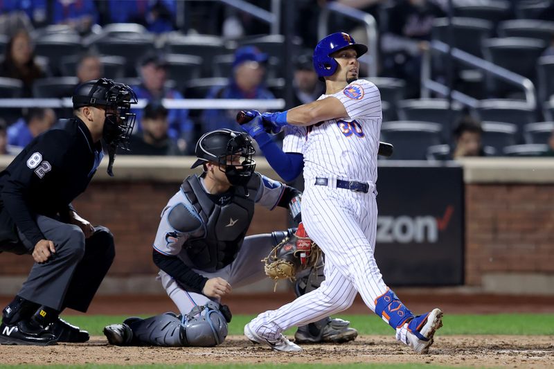 Sep 28, 2023; New York City, New York, USA; New York Mets center fielder Rafael Ortega (30) follows through on an RBI double against the Miami Marlins during the eighth inning at Citi Field. Mandatory Credit: Brad Penner-USA TODAY Sports