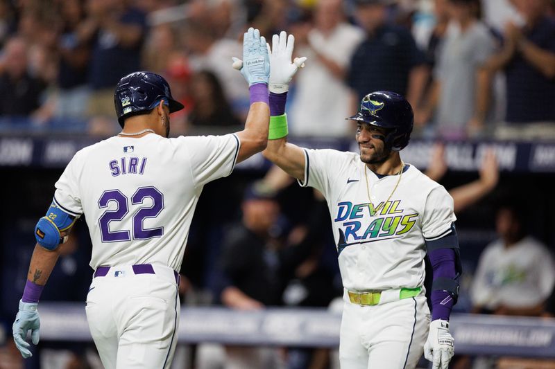 Jun 28, 2024; St. Petersburg, Florida, USA;  Tampa Bay Rays shortstop Jose Caballero (7) congratulates outfielder Jose Siri (22) after hitting a home run against the Washington Nationals in the second inning at Tropicana Field. Mandatory Credit: Nathan Ray Seebeck-USA TODAY Sports