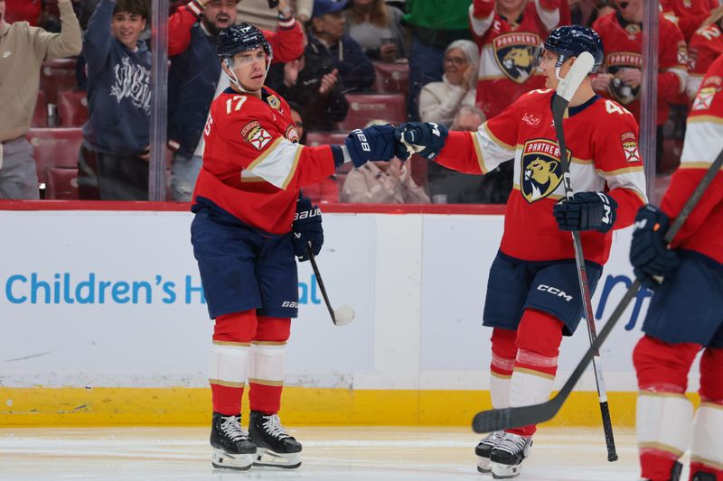 Nov 28, 2025; Sunrise, Florida, USA;Florida Panthers center Evan Rodrigues (17) celebrates with defenseman Gustav Forsling (42) after scoring against the Calgary Flames during the first period at Amerant Bank Arena. Mandatory Credit: Sam Navarro-Imagn Images
