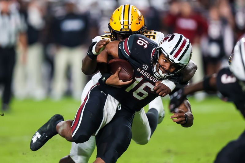 Nov 16, 2024; Columbia, South Carolina, USA; South Carolina Gamecocks quarterback LaNorris Sellers (16) is brought down by Missouri Tigers defensive end Jaylen Brown (93) in the second half at Williams-Brice Stadium. Mandatory Credit: Jeff Blake-Imagn Images