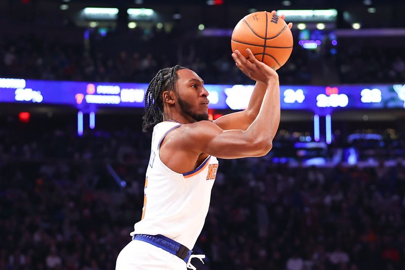 NEW YORK, NEW YORK - DECEMBER 25: Immanuel Quickley #5 of the New York Knicks shoots during the first quarter of the game against the Milwaukee Bucks at Madison Square Garden on December 25, 2023 in New York City.  NOTE TO USER: User expressly acknowledges and agrees that, by downloading and or using this photograph, User is consenting to the terms and conditions of the Getty Images License Agreement. (Photo by Rich Graessle/Getty Images)