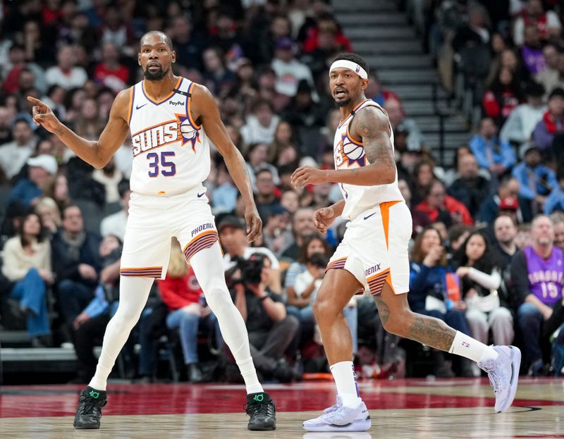 TORONTO, CANADA - FEBRUARY 23: Kevin Durant #35 of the Phoenix Suns and Bradley Beal #3 look on against the Toronto Raptors during the second half at Scotiabank Arena on February 23, 2025 in Toronto, Canada. NOTE TO USER: User expressly acknowledges and agrees that, by downloading and or using this photograph, User is consenting to the terms and conditions of the Getty Images License Agreement. (Photo by Kevin Sousa/Getty Images)