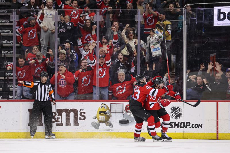 Jan 22, 2024; Newark, New Jersey, USA; New Jersey Devils right wing Tyler Toffoli (73) celebrates his game-winning goal in overtime against the Vegas Golden Knights with defenseman Luke Hughes (43) at Prudential Center. Mandatory Credit: Vincent Carchietta-USA TODAY Sports