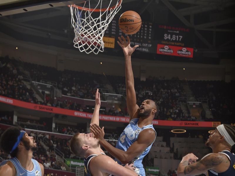 CLEVELAND, OH - DECEMBER 8: Evan Mobley #4 of the Cleveland Cavaliers shoots the ball during the game against the Denver Nuggets on December 5, 2024 at Rocket Mortgage FieldHouse in Cleveland, Ohio. NOTE TO USER: User expressly acknowledges and agrees that, by downloading and/or using this Photograph, user is consenting to the terms and conditions of the Getty Images License Agreement. Mandatory Copyright Notice: Copyright 2024 NBAE (Photo by David Liam Kyle/NBAE via Getty Images)