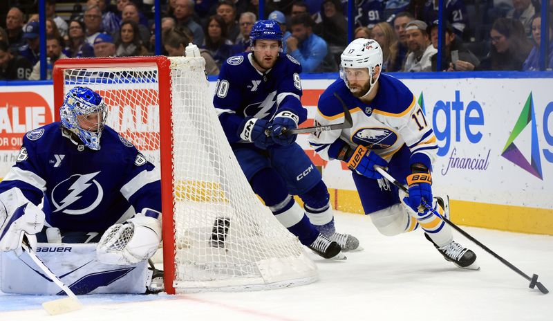 Feb 3, 2026; Tampa, Florida, USA; Buffalo Sabres left wing Jason Zucker (17) skates with the puck as Tampa Bay Lightning defenseman J.J. Moser (90) defends during the second period at Benchmark International Arena. Mandatory Credit: Kim Klement Neitzel-Imagn Images